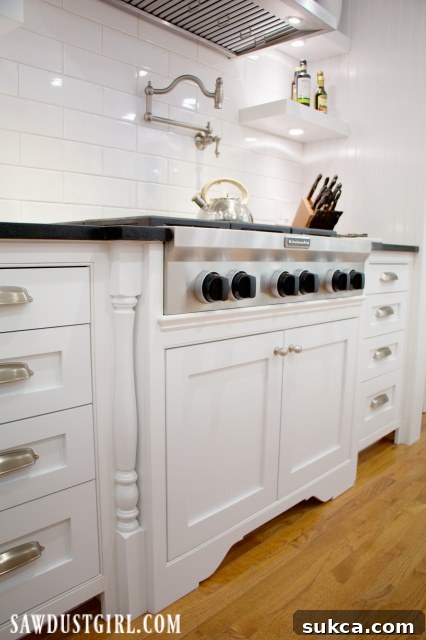 Close-up of a gas cooktop cabinet featuring elegant decorative legs.