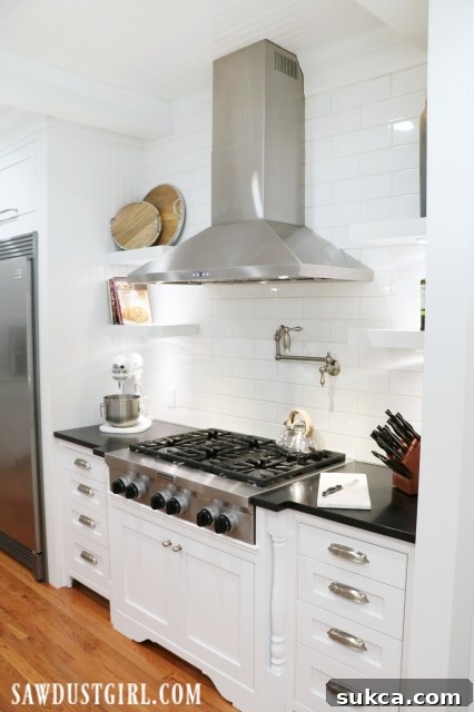 Kitchen reveal featuring a cooktop with custom cabinetry and decorative legs.