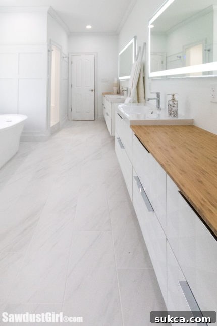 Luxurious master bathroom after rapid renovation, featuring a modern soaking tub, walk-in shower, and elegant vanity