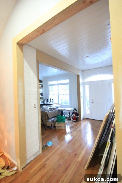 After photo of a bright, open entryway flowing into a library, showcasing increased natural light and an expanded doorway.