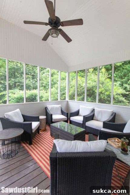 Detailed view of the screened porch, showing comfortable seating and views of the surrounding area.