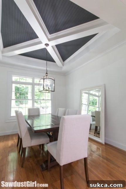 Spacious dining room showing the wide archway and custom ceiling design.