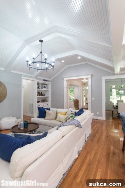 Overview of living space, showing dining room to the right and kitchen behind the sofa.