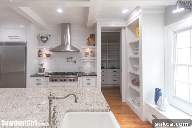Wide view of a well-organized kitchen with central island and multiple workstations.