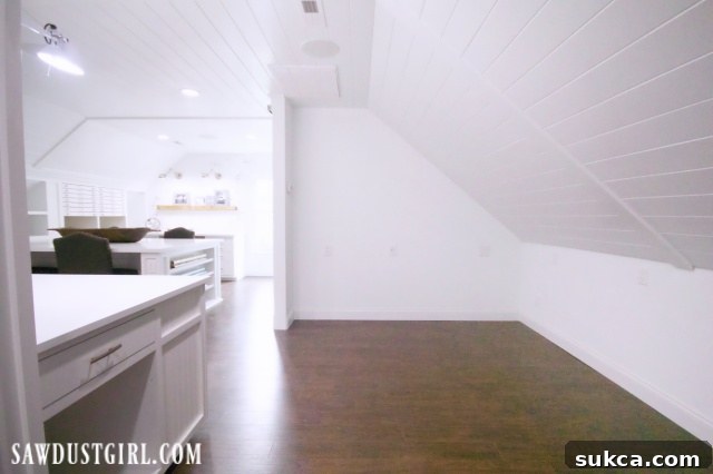 A modern and organized craft room with a clear view of the potential and ample space for various creative activities.