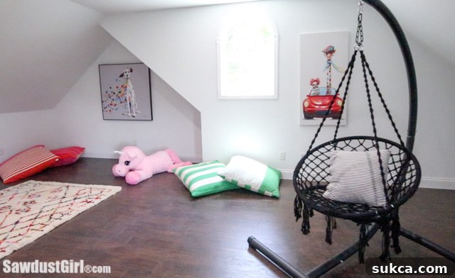colorful kids' play area featuring a teepee, soft rug, and various toys, demonstrating a fun and functional space.