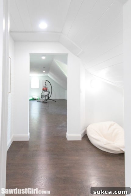 a cozy hallway nook featuring two modern bean bags, leading into another room, highlighting a relaxed seating area.