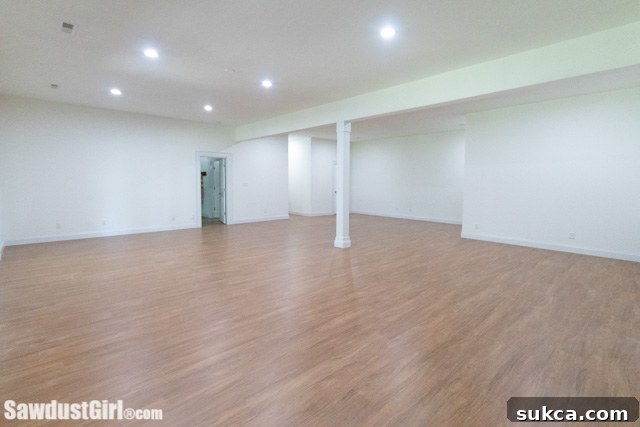 Before and after view of a renovated basement with high ceilings