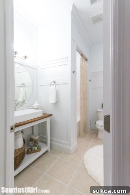 Before and after view of a basement bathroom with new wainscoting