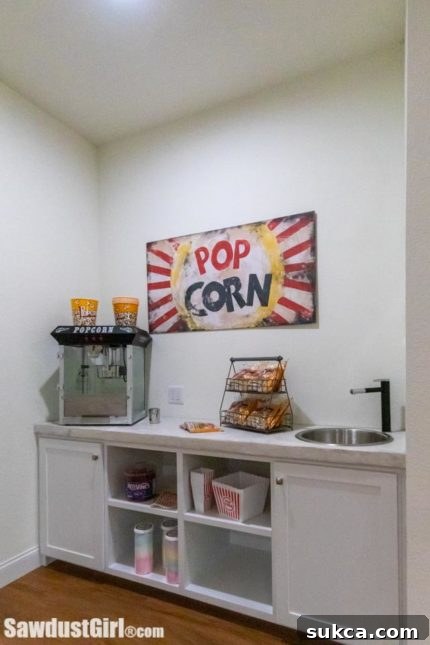 Decorated wet bar area with a popcorn machine and vintage sign