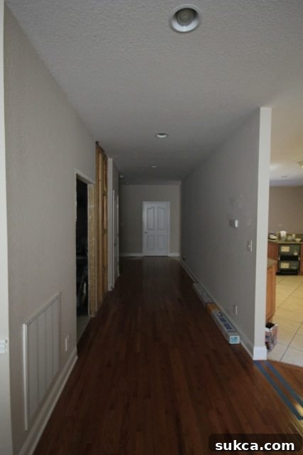 Main hallway before renovation, showing framing for pocket door