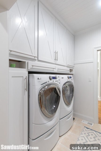 Deep custom cabinets over washer and dryer with efficient storage