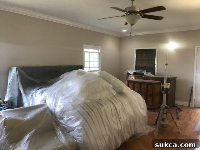 Master Bedroom After Transformation Transformed master bedroom with fresh white paint and new light fixture