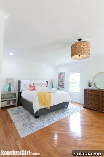 Elegant Bedside Tables in Master Bedroom Master bedroom with custom wicker light fixture and elegant bedside tables