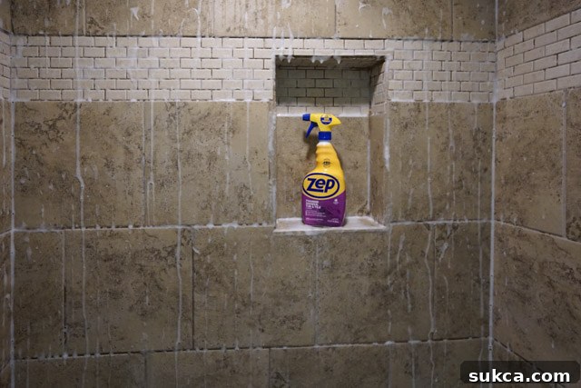 Spraying shower cleaner Applying Zep shower cleaner