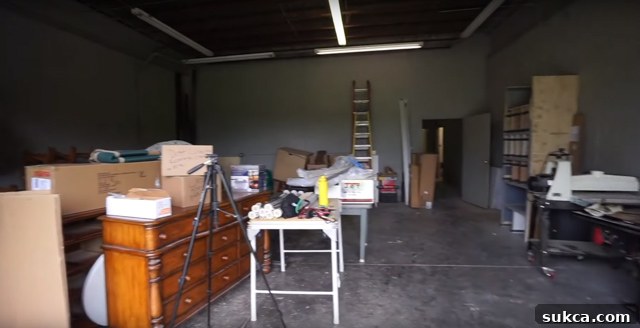 Large workshop bay currently used for furniture and tool storage