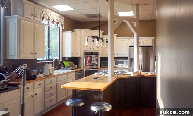 Kitchen Light Fixture Before Removal Kitchen space with a prominent light fixture before removal