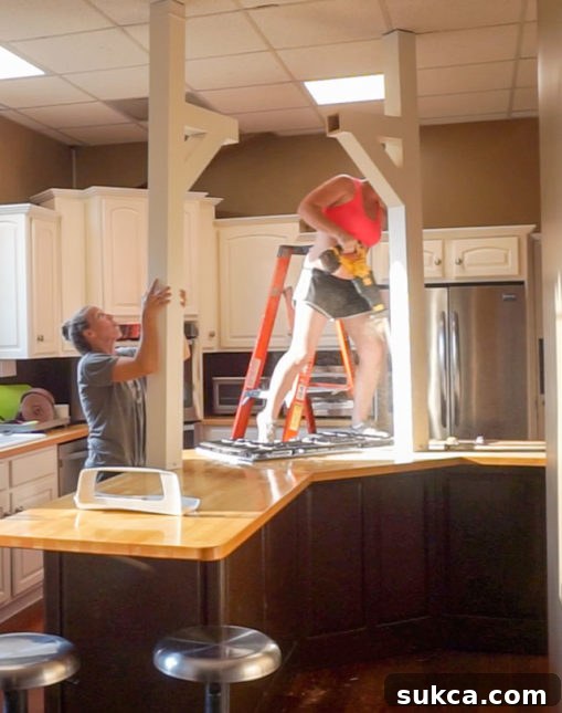 Cooktop Beam Partial Removal with Tubing Partially removed kitchen fake beam, showing exposed wide tubing