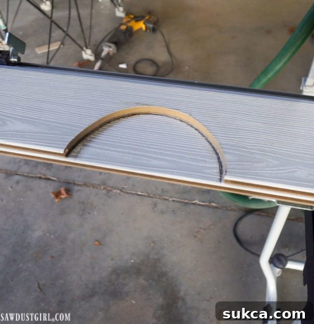Demonstration of using a paper template to accurately mark and draw circles on ceiling planks for recessed lighting.