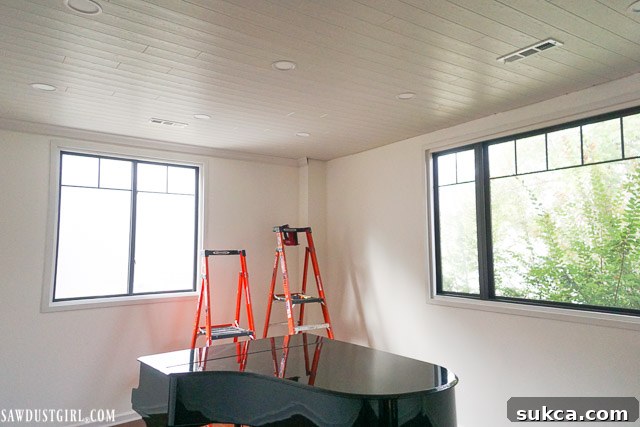 Crown moulding perfectly installed, concealing the expansion gap and adding an elegant finish to the WoodHaven plank ceiling.