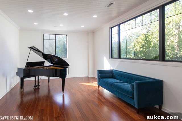 The newly installed Armstrong Ceilings WoodHaven Planks in the Piano Room, showcasing the complete ceiling transformation.