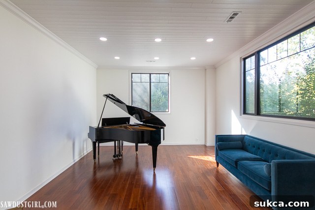 The stunning 'after' photo of the Piano Room, showcasing the beautiful new WoodHaven plank ceiling that replaced the ugly drop ceiling.