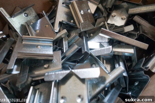 Close-up of Easy Up clips designed for secure installation on a drop ceiling grid, showing their robust design.