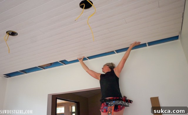 Detail showing how WoodHaven planks attach to a suspended ceiling grid, highlighting the seamless connection points.