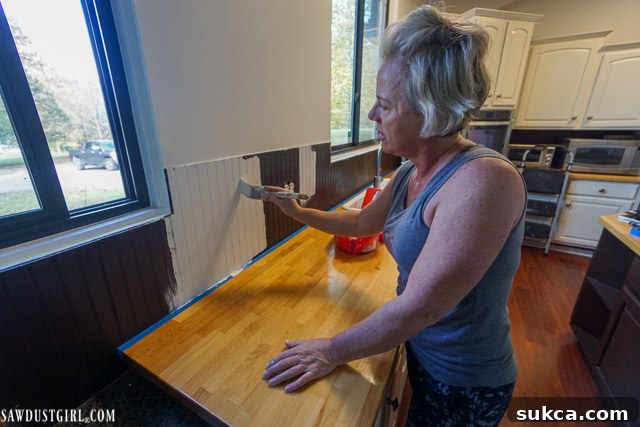 Painting Beadboard Backsplash Painting a beadboard backsplash white, showcasing the smooth technique and excellent coverage achieved with quality paint and tools.