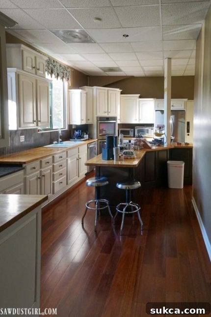 Dated Kitchen Before Makeover Before Kitchen Transformation: A look at the dated, dark brown-green kitchen prior to its paint refresh.