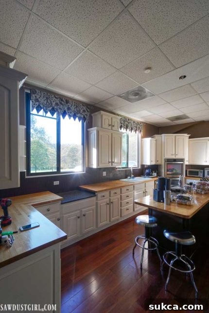 Kitchen Before Paint Transformation Before the kitchen refresh: Dark walls and tired decor creating a cramped and uninviting atmosphere.