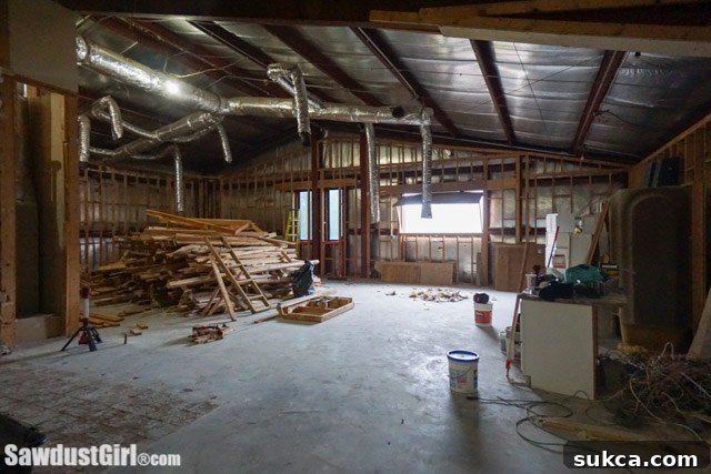 View of the vast, unfinished gathering room and kitchen area, showcasing its open-plan potential.