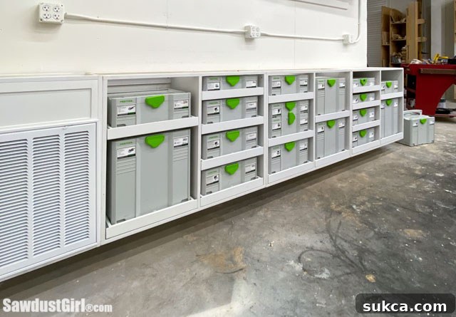 Custom workshop cabinets with shallow drawers for Festool Systainers, neatly organized.