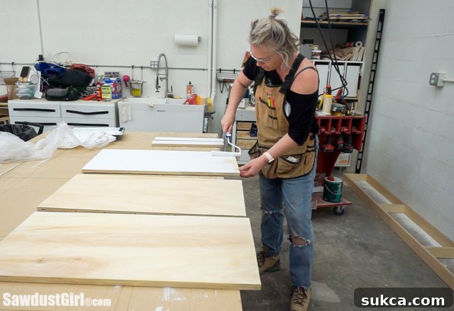 Pre-priming cabinet parts before full assembly.