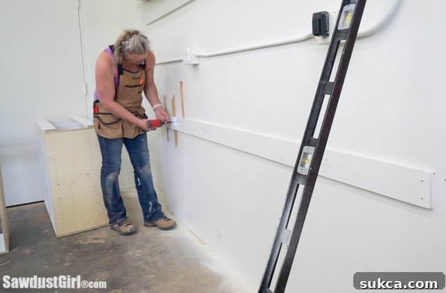 Shimming a wall cleat to compensate for an uneven wall.