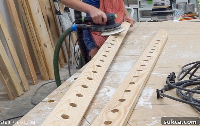 Electric sanding the surface of a ladder leg after drilling