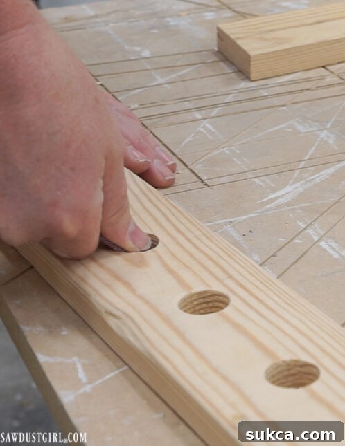 Hand sanding around the dowel holes for a smooth finish