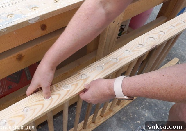 Inserting the dowels into the first ladder leg after applying glue