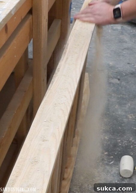 Close-up of dowels being hammered into place for a secure fit