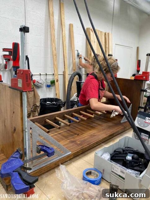 Craft Your Own Bench with Integrated Boot Storage 28 Clamping the assembled boot rack bench while glue cures