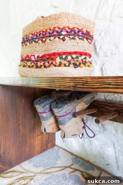 Craft Your Own Bench with Integrated Boot Storage 29 Finished boot rack bench in an organized entryway