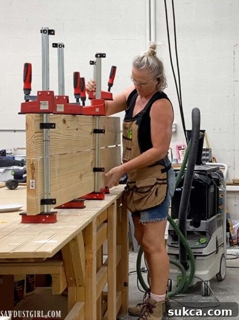 Craft Your Own Bench with Integrated Boot Storage 9 Clamping glued wood planks for a wide bench piece