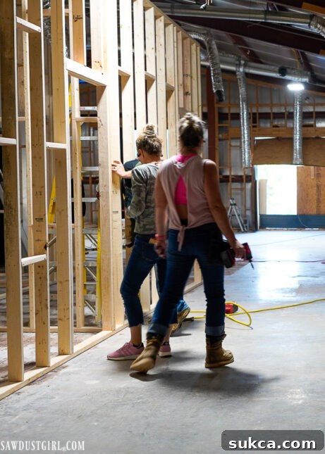 Working together on The Lodge's framing Team members working on framing a wall