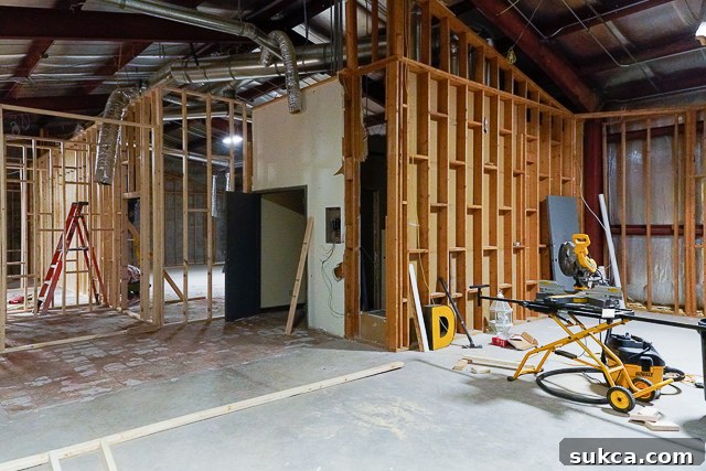 Before and after view of the interior space, showing initial framing adjustments