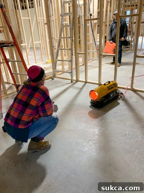 Working in Varied Weather Team member working on wall framing, dressed in layers due to fluctuating temperatures