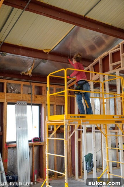 Insulation Removal Process Old insulation being removed from the ceiling of The Lodge