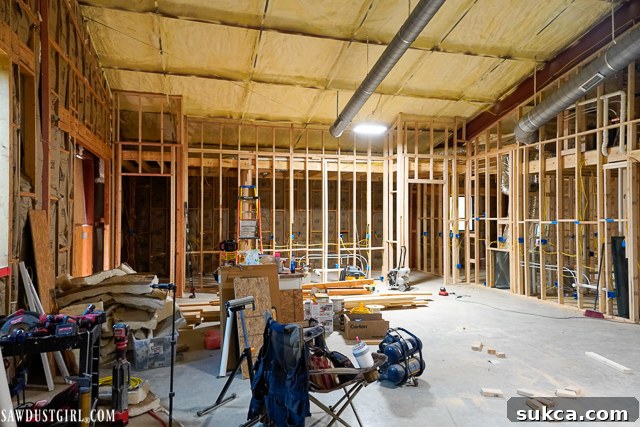 Another view of the Lodge's interior with extensive rough-in work completed, showing the intricate network of pipes and wires that form the home's essential systems.