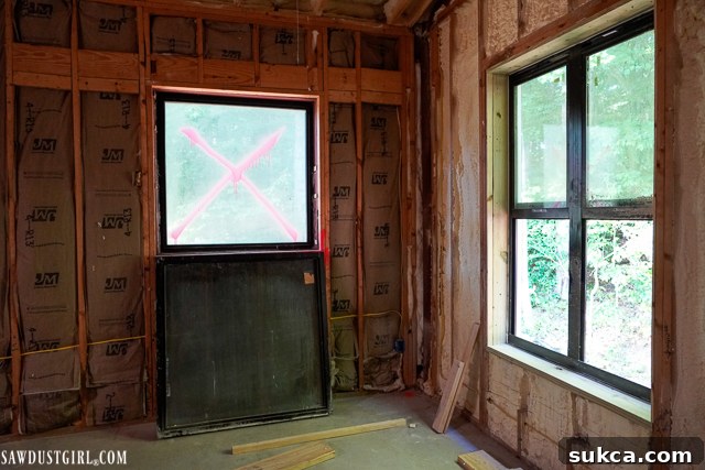 Exterior view of the Lodge under construction, showing a distinct lack of windows and siding, emphasizing the current challenge and bottleneck in the project timeline.