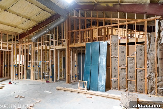 An overview of the Lodge's interior with completed framing, ceiling joists, and subfloor, showing a major construction milestone in the framing progress.