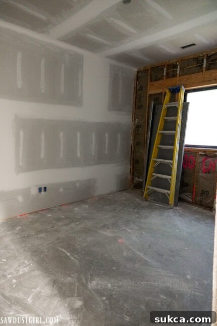 Lodge Drywall Installation Update 5 16 Office space with one wall left unfurnished, awaiting decision on window conversion to door